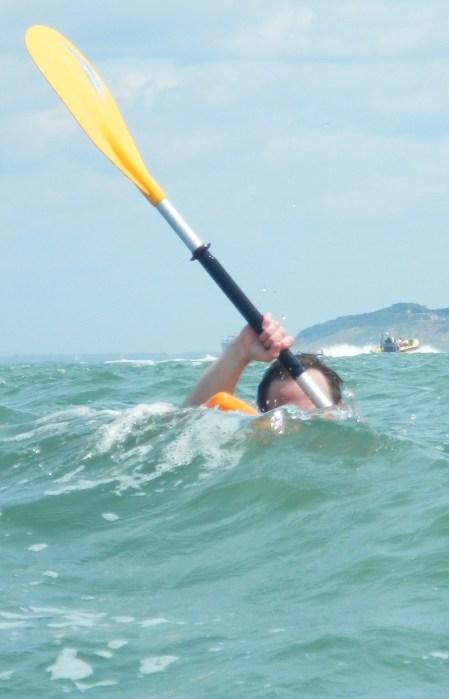 A kayaker plays inthe swell by the Needles, Isle of Wight